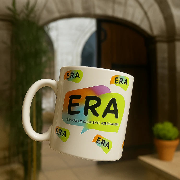 White mug with colorful 'ERA' branding in an outdoor setting